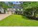 Charming two-story home with a well-manicured lawn, inviting front porch, and an attached two-car garage at 119 Laurel Mill Ct, Roswell, GA 30076
