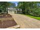 Traditional two-story home with a two-car garage, long driveway, and professionally landscaped front yard at 119 Laurel Mill Ct, Roswell, GA 30076
