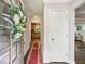 Inviting home foyer with hardwood floors, a decorative wreath, and views into the kitchen and living areas at 119 Laurel Mill Ct, Roswell, GA 30076