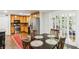 Spacious kitchen with stainless steel appliances, wooden cabinets, and a dining area that opens to sunroom at 119 Laurel Mill Ct, Roswell, GA 30076