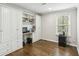 Bright office features hardwood floors, built-in cabinets, shelving, and a desk area at 119 Laurel Mill Ct, Roswell, GA 30076
