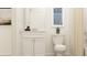 Bright white half-bath featuring modern sink, vanity, and decor, offering a clean and welcoming space at 2483 Cotton Ln, Douglasville, GA 30135
