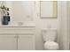 Bright half-bath features modern vanity, neutral patterned shower curtain, and stylish decor at 2483 Cotton Ln, Douglasville, GA 30135