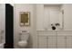 Modern half-bath features a dual sink vanity, sleek black shower curtain, and a large decorative mirror at 2483 Cotton Ln, Douglasville, GA 30135