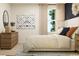 Serene bedroom with elegant decor, a comfortable bed, and a dresser complemented by a chic mirror at 2483 Cotton Ln, Douglasville, GA 30135