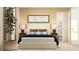 Warm bedroom with modern bed, en-suite bathroom access, and large decorative plants at 2483 Cotton Ln, Douglasville, GA 30135