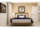Inviting bedroom with a wooden bed frame, modern art, natural light, and neutral color palette at 2483 Cotton Ln, Douglasville, GA 30135