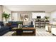Cozy living room featuring a comfortable sectional sofa, wooden coffee table, and stylish decor at 2483 Cotton Ln, Douglasville, GA 30135
