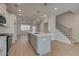 Bright kitchen with stainless steel appliances, a large island, and staircase access at 3336 Cranston Ln, Kennesaw, GA 30144