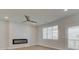 Bright living room with a ceiling fan, fireplace, and windows with pleasant natural light at 3336 Cranston Ln, Kennesaw, GA 30144