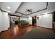 A finished basement with hardwood floors, ceiling fan, and sitting area at 685 Sienna Dr, Cumming, GA 30040