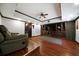 Finished basement featuring hardwood flooring, custom built-ins, and a ceiling fan at 685 Sienna Dr, Cumming, GA 30040
