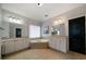 Bright bathroom with double vanity, soaking tub and black interior doors at 685 Sienna Dr, Cumming, GA 30040