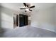 Neutral bedroom with ceiling fan and black doors leading into other rooms at 685 Sienna Dr, Cumming, GA 30040