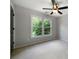 Bedroom with a ceiling fan and a large window looking out to mature trees at 685 Sienna Dr, Cumming, GA 30040