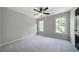 Bright, airy bedroom with neutral walls, carpet, a ceiling fan, and natural light at 685 Sienna Dr, Cumming, GA 30040