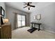 Bedroom features neutral paint, carpet, modern ceiling fan, and natural light at 685 Sienna Dr, Cumming, GA 30040