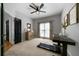 Bedroom has neutral walls, natural light, closet, and carpet, with a treadmill for convenience at 685 Sienna Dr, Cumming, GA 30040