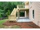 View of a new wooden deck and concrete patio featuring wooden stairs, landscaping, and outdoor lighting at 685 Sienna Dr, Cumming, GA 30040