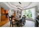 Charming dining area with modern light fixture, large windows, and a glimpse into the kitchen at 685 Sienna Dr, Cumming, GA 30040
