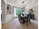 Stylish dining room showcasing modern lighting, a large window, and seating for six at 685 Sienna Dr, Cumming, GA 30040