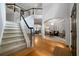Grand foyer with high ceilings, staircase, wood floors, and an open view to the living room at 685 Sienna Dr, Cumming, GA 30040