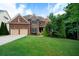 Charming brick two-story home boasts a well-manicured lawn, attached two-car garage, and mature landscaping at 685 Sienna Dr, Cumming, GA 30040