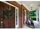 Inviting front porch featuring classic rocking chairs, a decorative wreath, and brick accents at 685 Sienna Dr, Cumming, GA 30040
