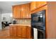 Kitchen boasts wood cabinets, granite countertops, stainless steel appliances, and built-in microwave and oven at 685 Sienna Dr, Cumming, GA 30040