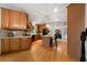 Kitchen boasts wood cabinets, hardwood floors, island with pendant lights, and open view to the dining area at 685 Sienna Dr, Cumming, GA 30040