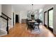 Bright living room with stairs, hardwood floors, access to deck, and open view to the dining area at 685 Sienna Dr, Cumming, GA 30040