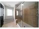 Tiled shower with frameless glass door, window and built in bench at 685 Sienna Dr, Cumming, GA 30040