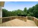 New wooden deck featuring wooden railings and stairs overlooking a lush backyard and surrounding trees at 685 Sienna Dr, Cumming, GA 30040