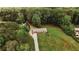 Aerial view of a charming single-story home with mature trees, expansive lawn and long driveway at 8394 Banks Mill Rd, Douglasville, GA 30135