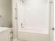 Bright bathroom featuring a white tub and shower combination with modern fixtures and accessibility support at 8394 Banks Mill Rd, Douglasville, GA 30135