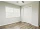 Clean bedroom with laminate flooring, double door closet, and a bright window at 8394 Banks Mill Rd, Douglasville, GA 30135