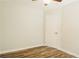 Spacious bedroom featuring laminate flooring and a door to a bedroom at 8394 Banks Mill Rd, Douglasville, GA 30135