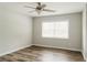 Neutral bedroom featuring ceiling fan, laminate flooring, and a bright window at 8394 Banks Mill Rd, Douglasville, GA 30135