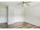 Cozy bedroom with hardwood floors, ceiling fan, and double door closet at 8394 Banks Mill Rd, Douglasville, GA 30135