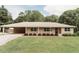 Charming single-story home with well-maintained lawn and covered parking at 8394 Banks Mill Rd, Douglasville, GA 30135