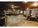 Spacious garage area featuring concrete floors, a workbench, and an electric golf cart at 8394 Banks Mill Rd, Douglasville, GA 30135