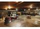 A spacious garage with a concrete floor, exposed wood ceiling, and an electric golf cart at 8394 Banks Mill Rd, Douglasville, GA 30135