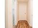 Clean hallway with hardwood floors, white walls, and doors leading to various rooms at 8394 Banks Mill Rd, Douglasville, GA 30135