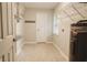Functional laundry room with shelving, utility sink, and an on-demand water heater at 8394 Banks Mill Rd, Douglasville, GA 30135