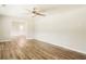 Airy living room featuring ceiling fan, hardwood floors, and neutral paint at 8394 Banks Mill Rd, Douglasville, GA 30135