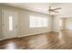 Bright living room with stylish ceiling fan and hardwood floors, perfect for gatherings at 8394 Banks Mill Rd, Douglasville, GA 30135