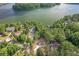 An aerial view of a luxury lakeside community with lush trees and beautiful waterfront homes at 912 Oak Dr, Woodstock, GA 30189