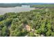 Scenic aerial view of a property nestled among lush trees, offering stunning lake views and natural beauty at 912 Oak Dr, Woodstock, GA 30189