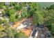 Aerial view of new construction home surrounded by woods with paved driveway and graded lawn at 912 Oak Dr, Woodstock, GA 30189