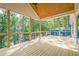 Wide back deck features natural wood floors and ceilings and a covered area with nice views of the water at 912 Oak Dr, Woodstock, GA 30189